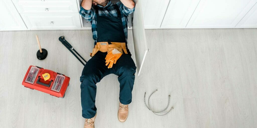 Top View Of Handyman Lying On Floor Near Toolbox Jzfjywd E1660389963310 - Citizen Plumbing &Amp; Heating Toronto